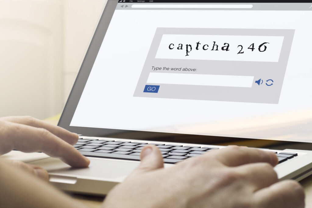 Man,Using,A,Laptop,With,Captcha,On,The,Screen.,Screen